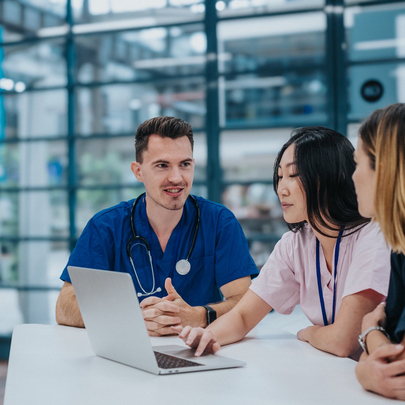 Doctors talking over laptop 