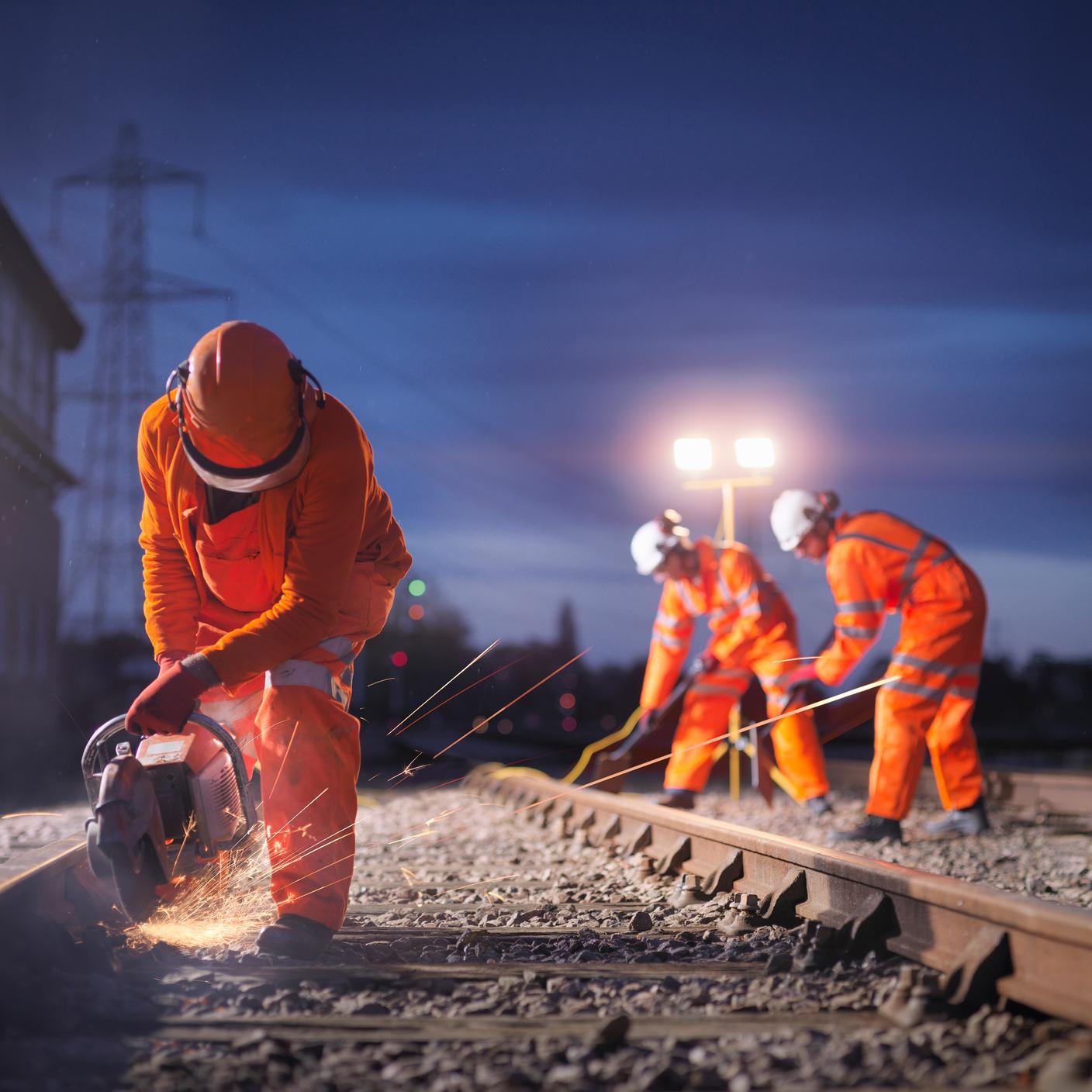 men working on train track 