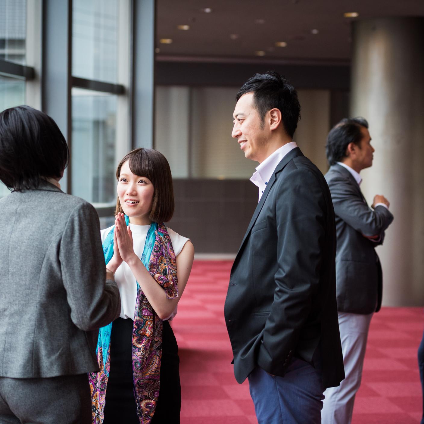 accelerating standards adoption in China - business team consultng during a break at a conference