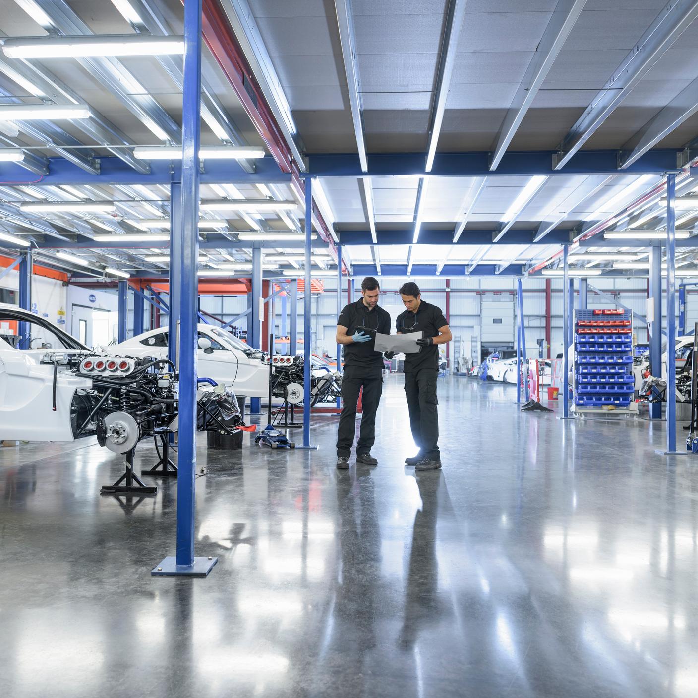 Engineers in construction area in racing car factory