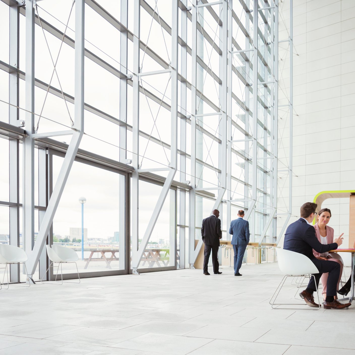 Business people discussing plans in modern lobby