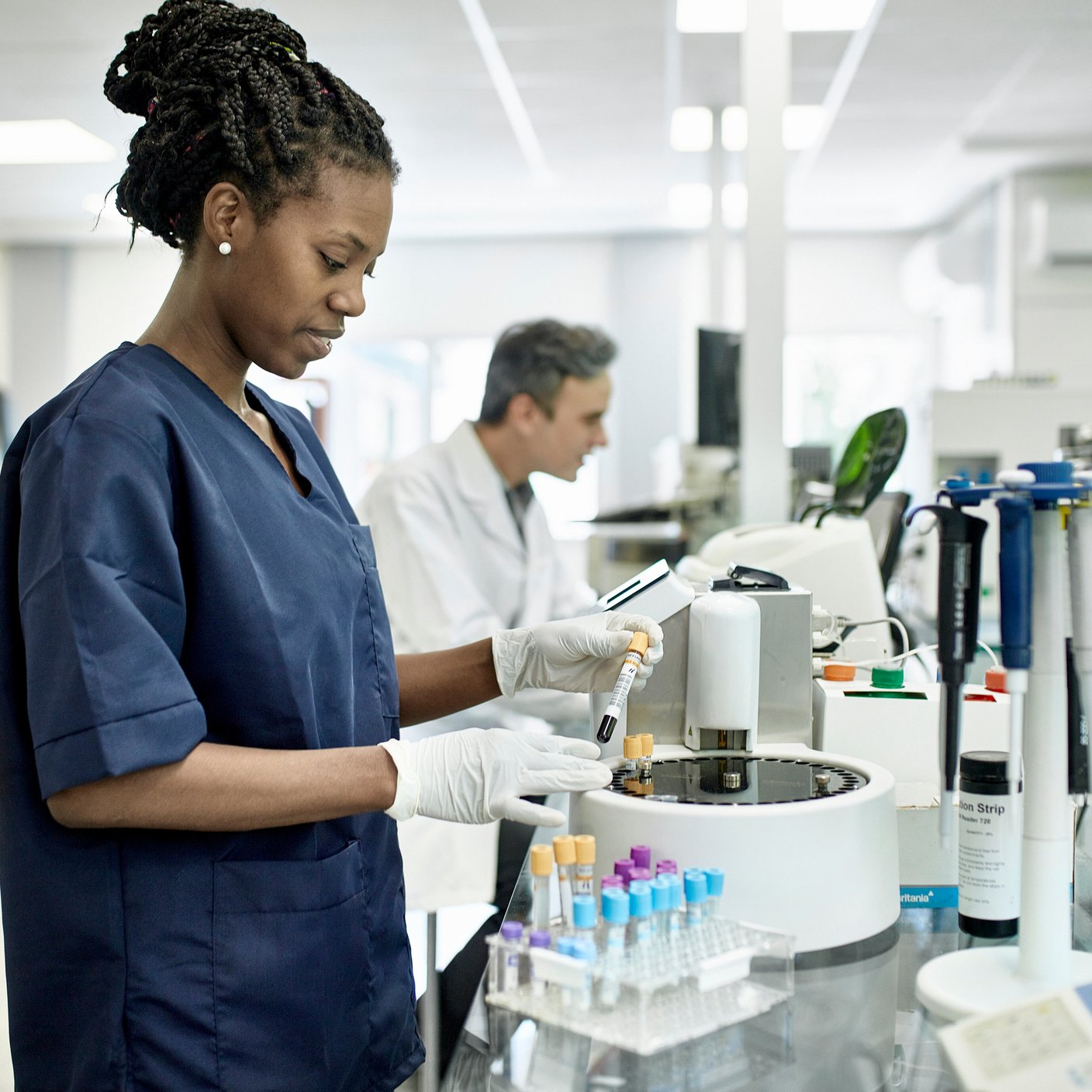 Technicien en pathologie portant une blouse bleue dans un laboratoire