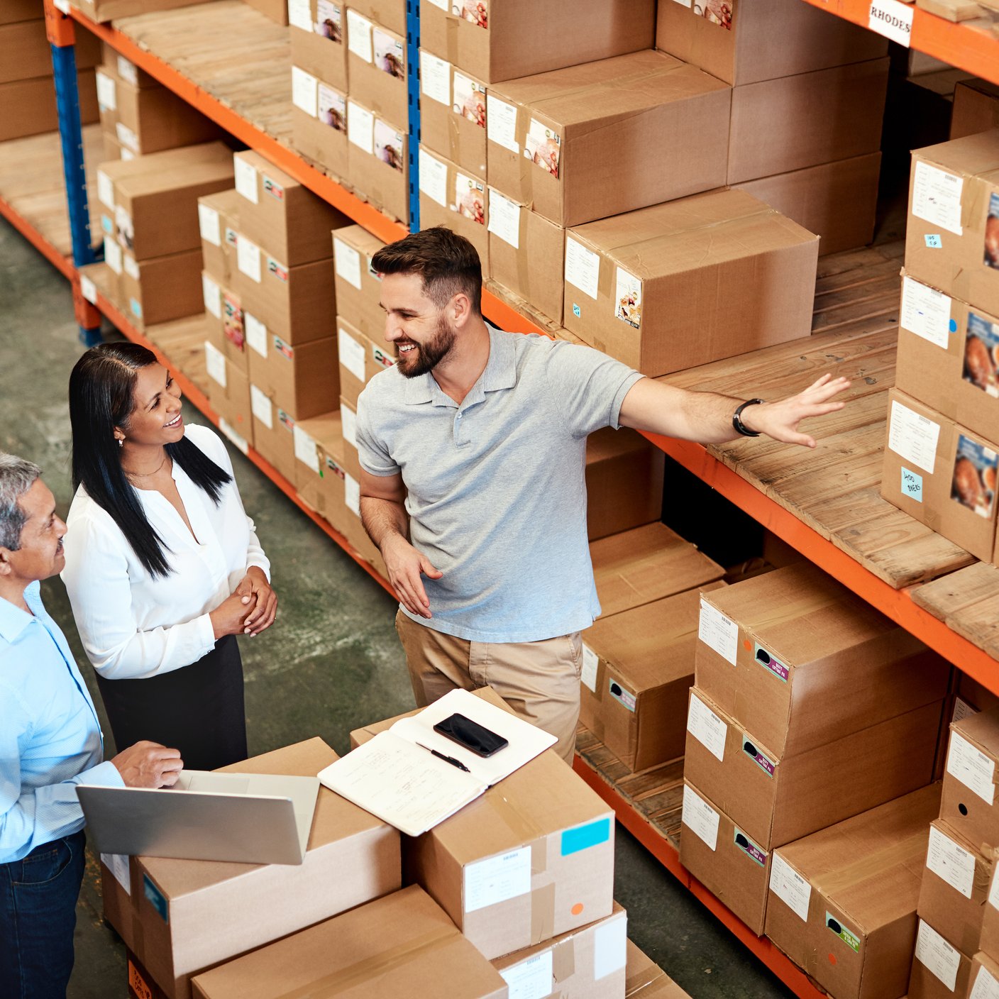 High angle shot of a group of factory workers having a discussion in a warehouse