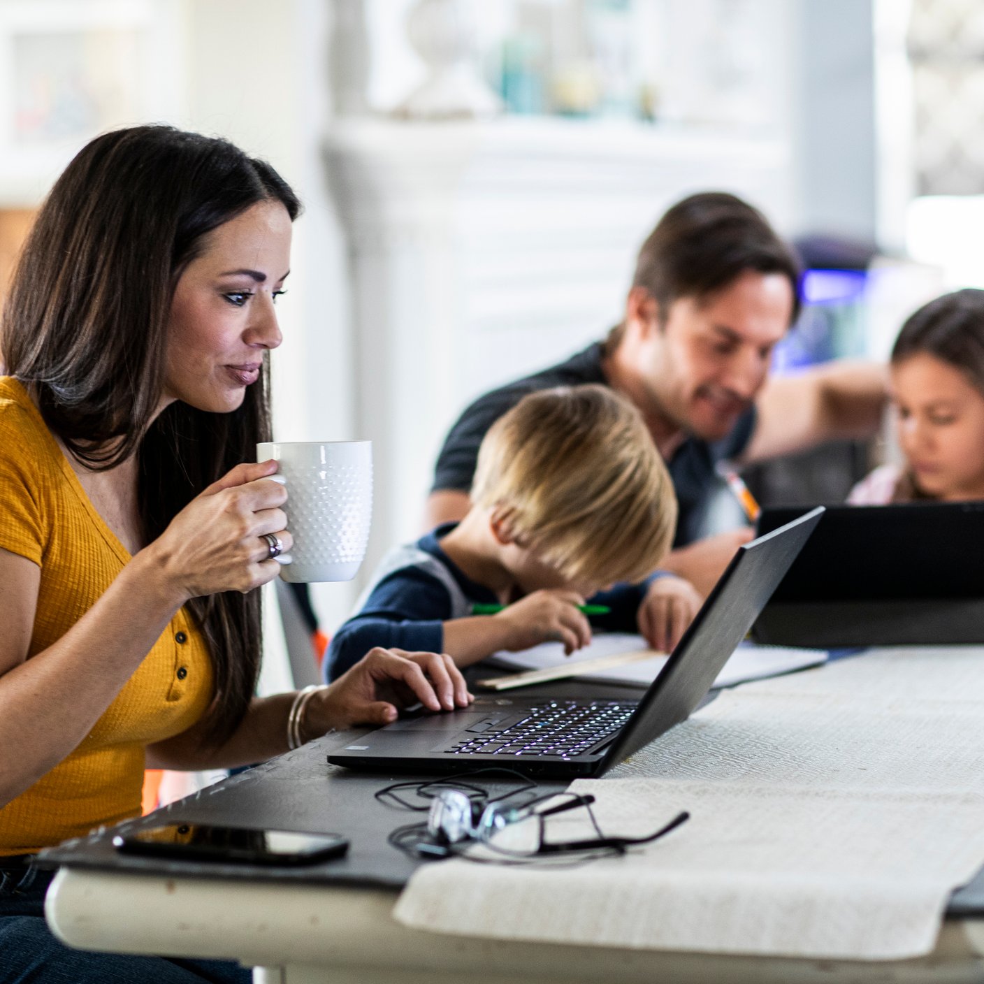 A mother working from home while her children are attending online school