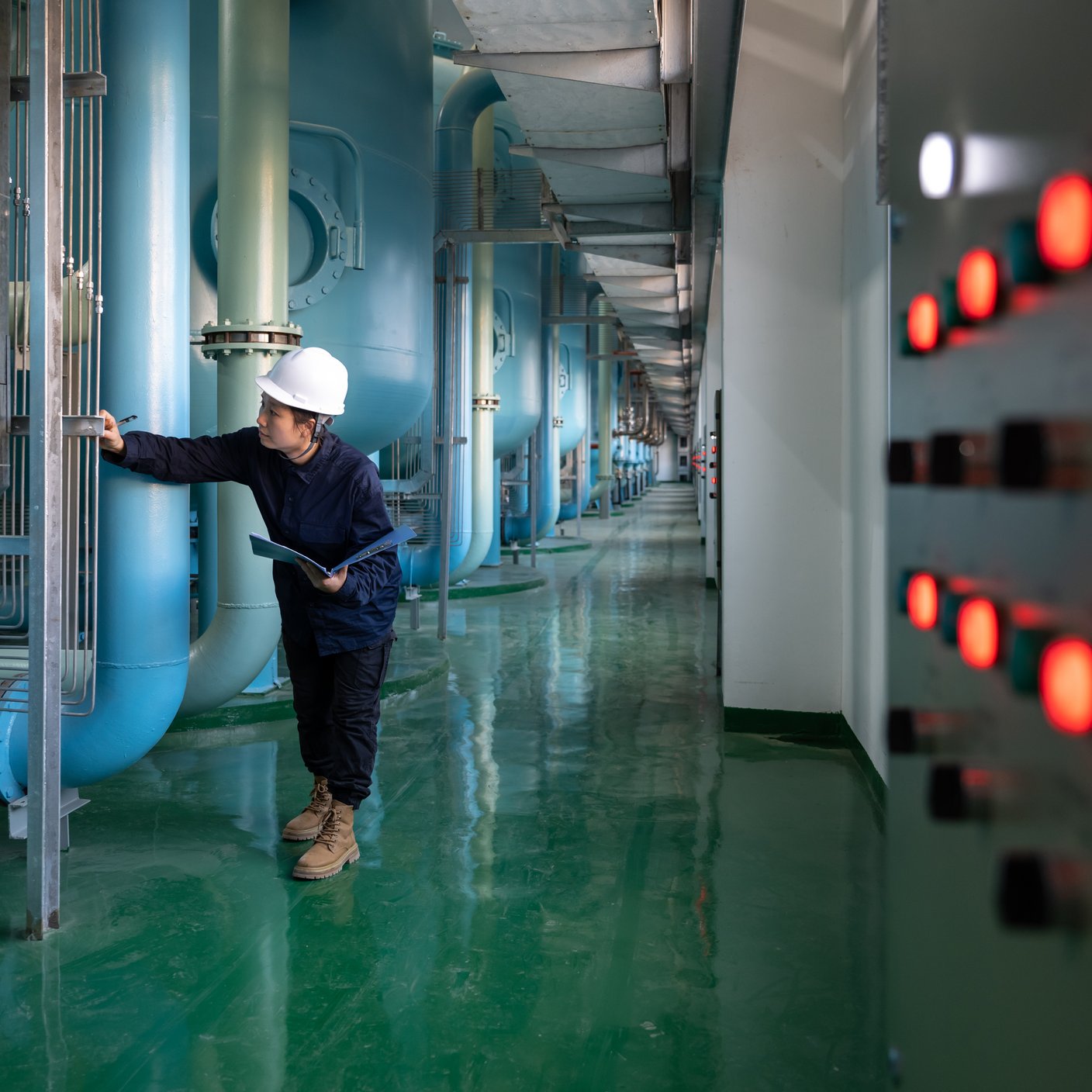 A female safety officer works in a chemical plant