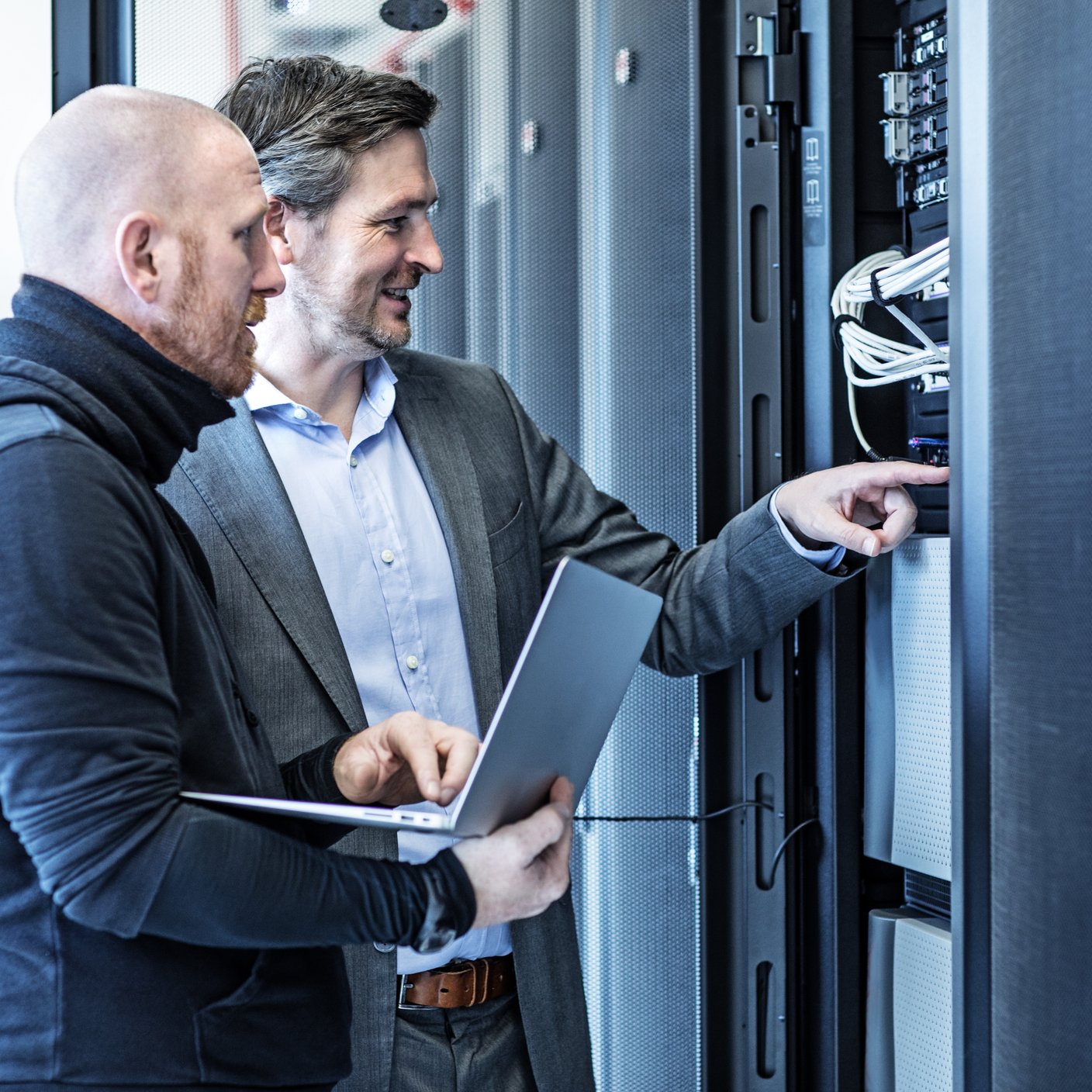 Technicians and Manager working together in Server Room Setting