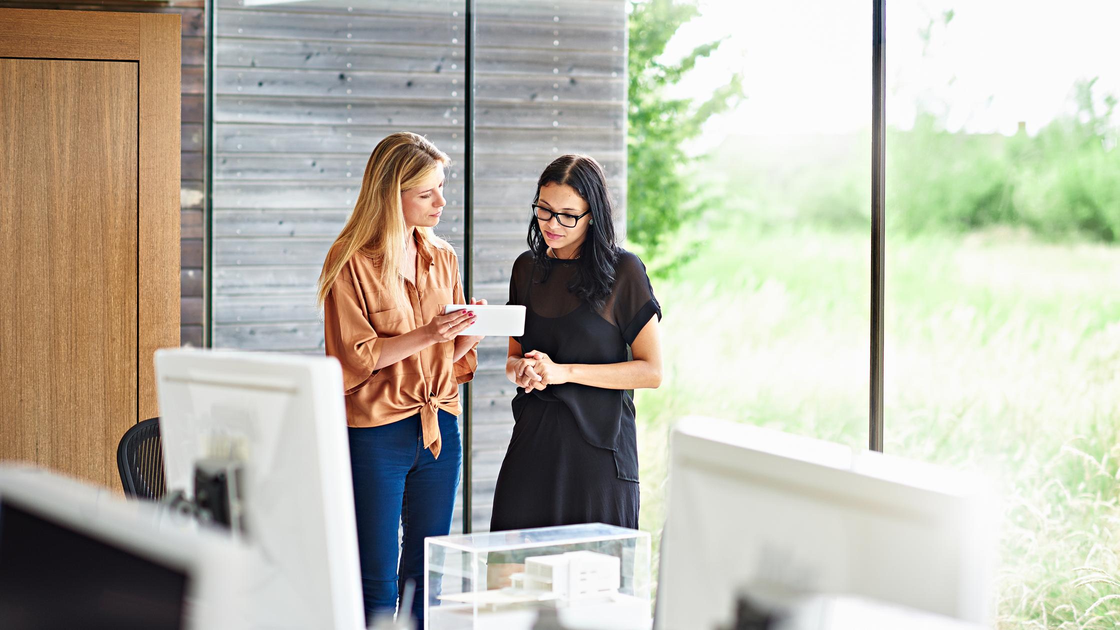 two women discussing in the office