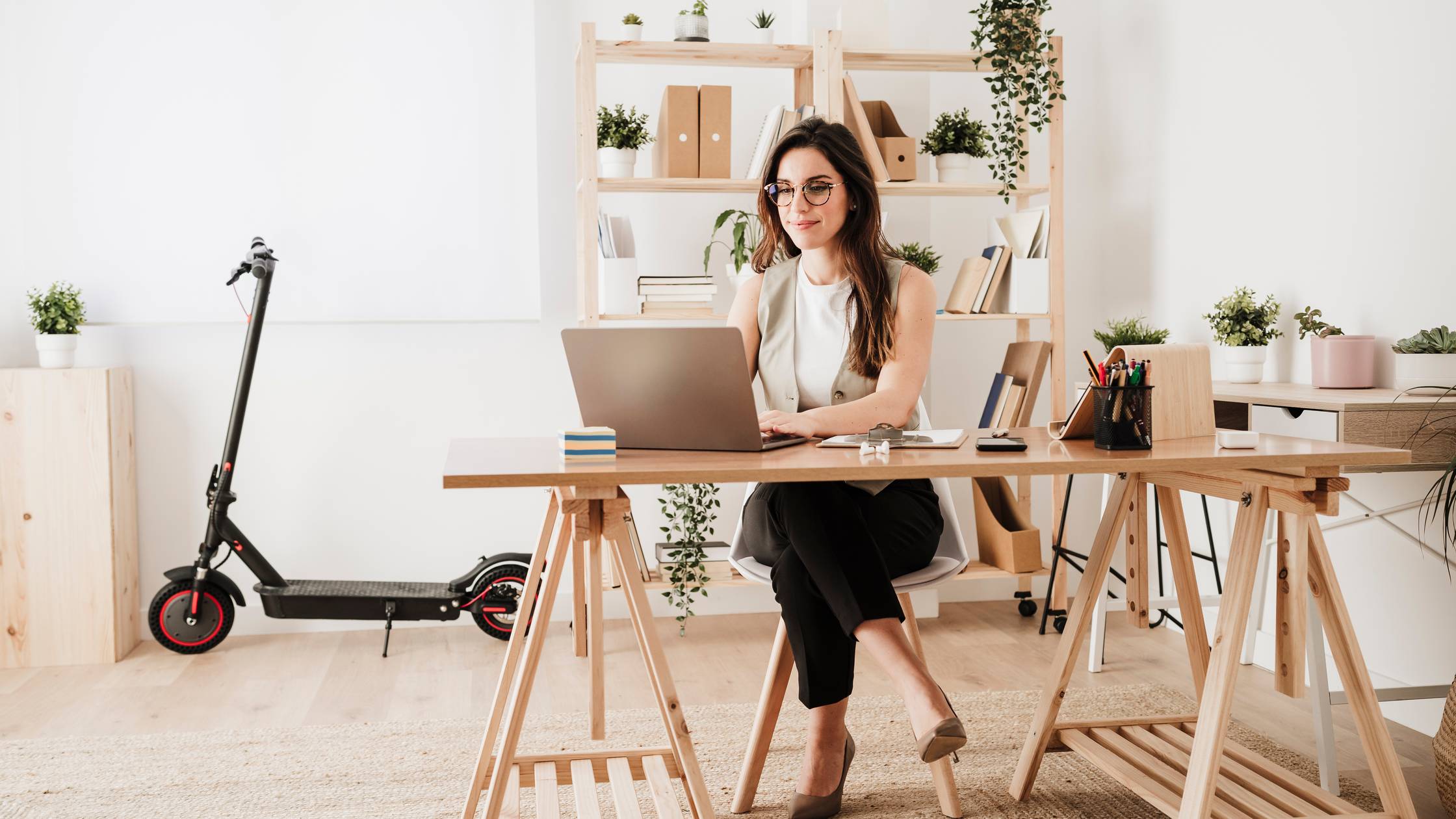 Businesswoman using laptop at desk in office