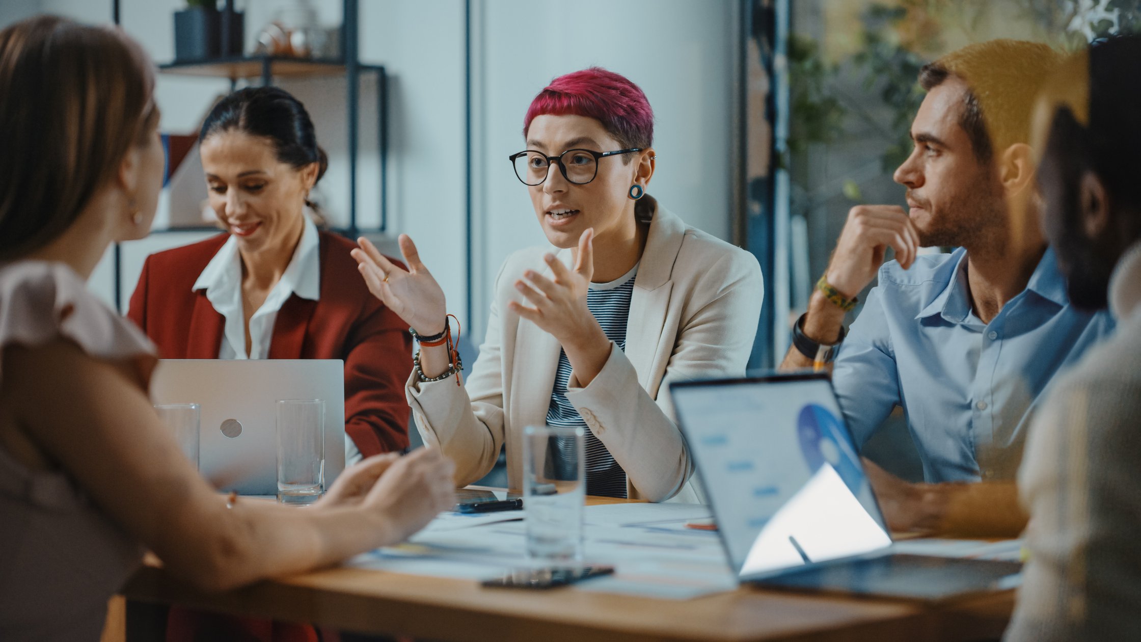 Creative start-up team discusses project in a meeting room