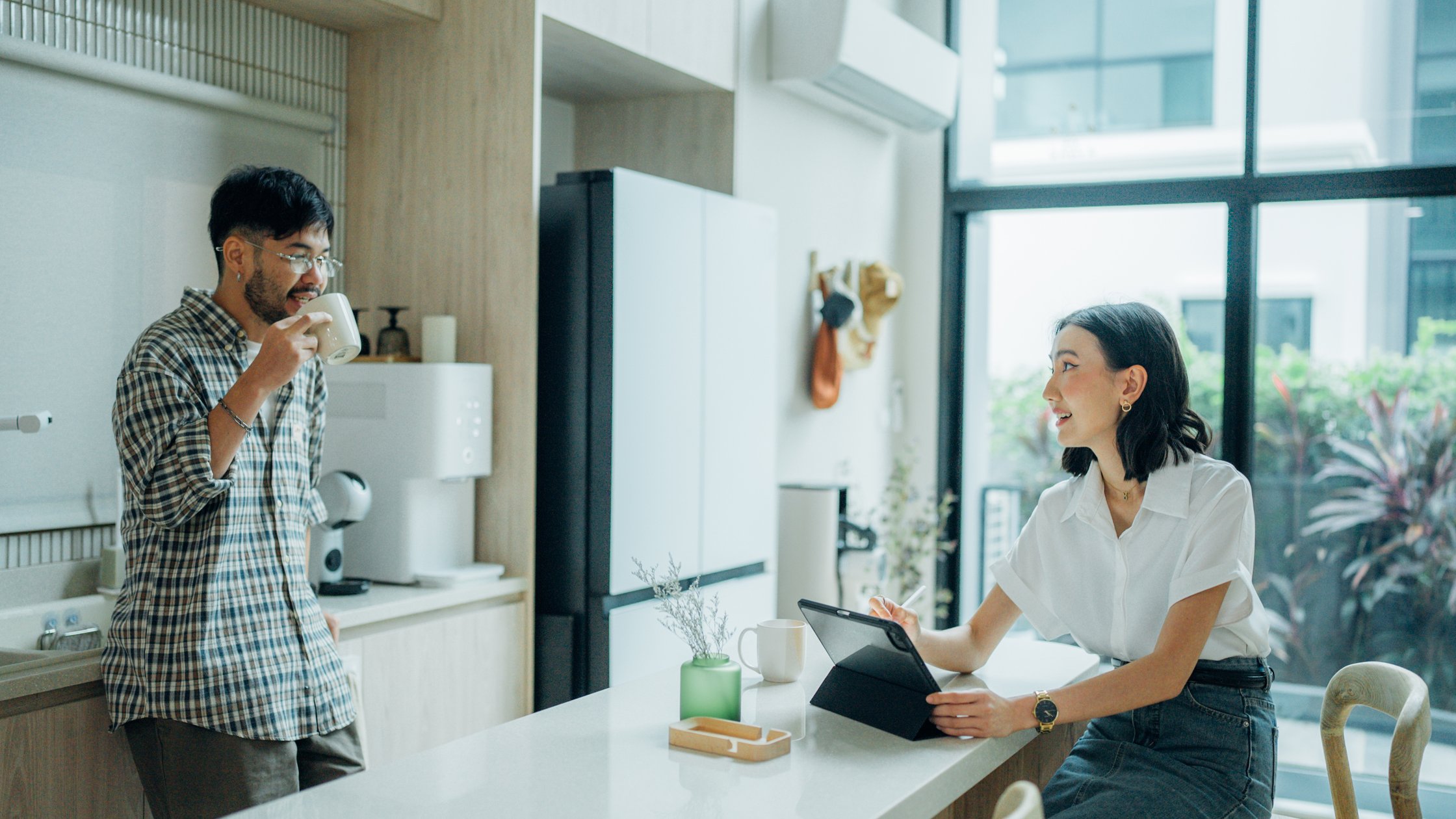 Coffee, talking and a happy couple at home.