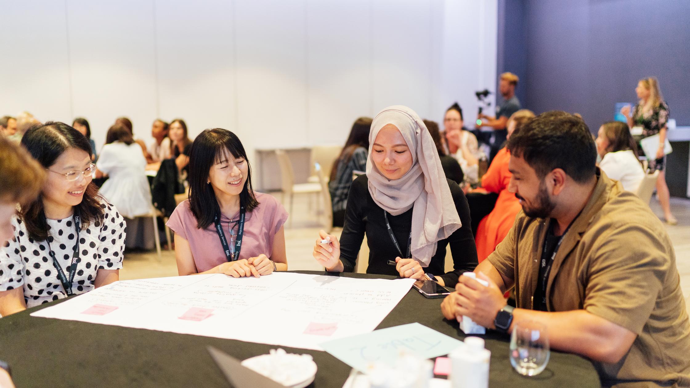 Man and women discussing around a table