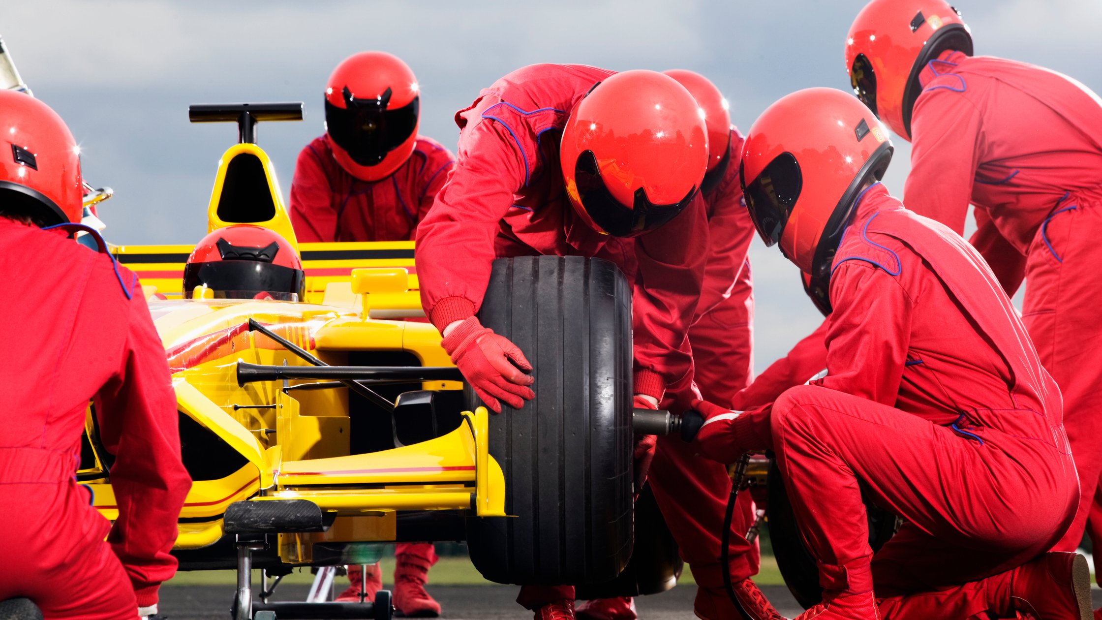 Pit crew changing a tyre.